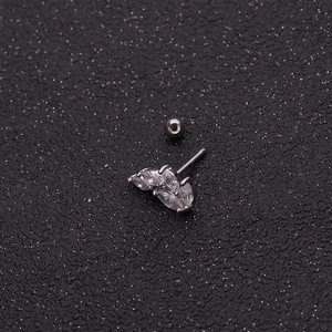 Macro detail of leaf-shaped cartilage stud with three marquise-cut zircons and ball back