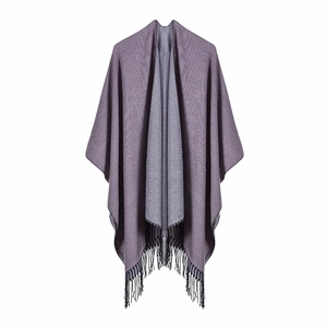 Close-up of double-sided knit shawl with muted purple texture and black tassel details