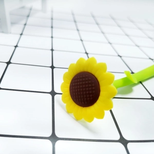 Close-up of a creative sunflower silicone gel pen featuring yellow petals and a green stem