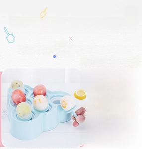 Detail of baby-blue silicone mini ice pop mold with fruit pieces and plastic handles
