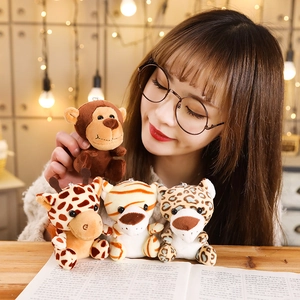 Plush jungle animal keychains featuring lion, tiger and giraffe on a wooden desk