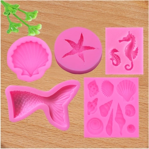 Pink silicone ocean themed molds with seashell starfish seahorse and mermaid tail shapes