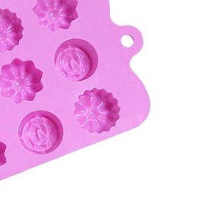 Close-up of pink silicone flower mold showing 15 cavities and hanging hole design