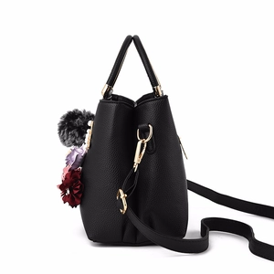 Black pebbled leather handbag for women with floral charms and golden hardware