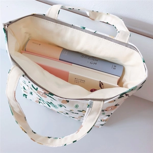 Top view of floral canvas tote bag with zipper showing spacious interior for two thick books