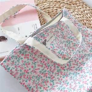 Floral canvas tote interior featuring small inner pocket and secure zipper closure