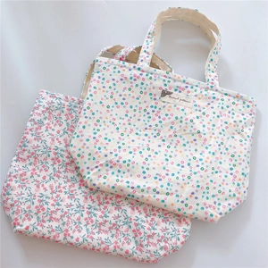 Flat lay view of cotton canvas tote bags featuring pink floral and colorful polka dot patterns