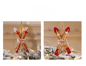 Close-up of wooden sled Christmas ornaments with plush pom-poms and metal bells