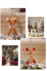 Close-up of wooden ski sledge Christmas ornament with small bells and red snowflakes
