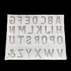 Detail view of white silicone mold for capital English letters A-Z and symbols for baking