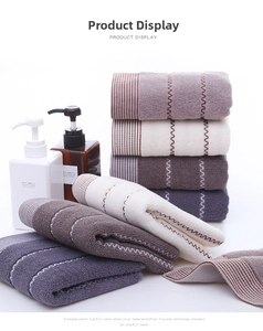Detailed view of colorful thick cotton towels with wave patterns and striped edges
