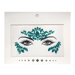 Close-up of emerald green face crystal stickers on white backing for festival makeup