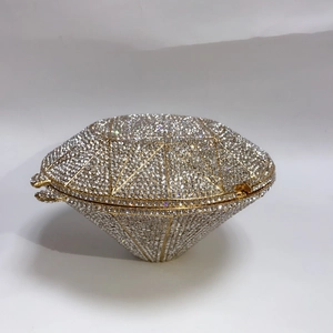 Detailed view of diamond-shaped clutch bag with silver rhinestones and gold metal frame
