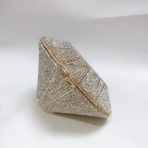 Side view of diamond-shaped evening clutch bag with sparkling silver crystals and gold trim