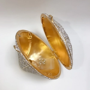 Close-up of diamond evening bag showing silver crystal exterior and golden inner lining