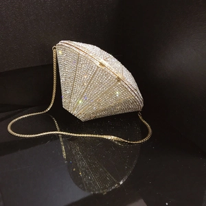 Macro shot of 3D diamond shaped evening clutch with crystals and gold chain strap