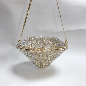 Close-up of diamond-shaped evening clutch with crystal rhinestones and gold chain