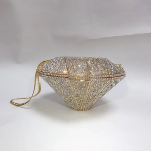 Detail of diamond-shaped clutch with silver rhinestones and gold metal frame finish