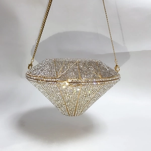 Close-up of diamond-shaped evening clutch featuring full crystal inlay and gold chain