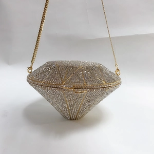 Detail of diamond-shaped silver crystal evening clutch with gold metal frame and chain