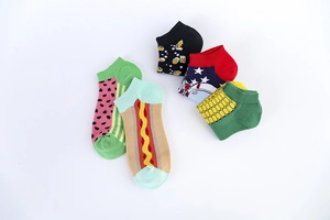 Flat lay of colorful cotton blend socks featuring creative watermelon and hot dog patterns