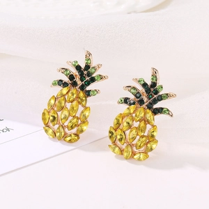 Close-up of golden pineapple stud earrings with sparkling yellow and green crystals