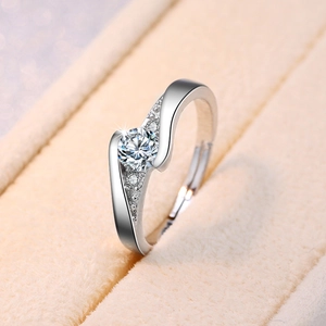 Macro view of silver bypass ring featuring large round zircon and sparkling side stones