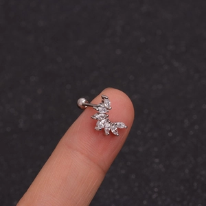 Macro shot of a silver curved stud earring with marquise cubic zirconia on a fingertip