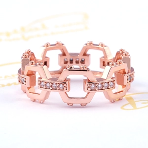 Macro shot of rose gold plated hexagonal chain ring with sparkling zircon inlay details