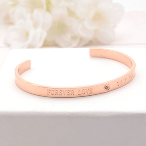 Rose gold stainless steel open bangle with Forever Love engraving and small zircon