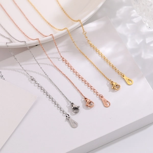 Macro shot of 18KGP lobster clasps and extension chains in gold, rose gold and silver