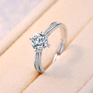 Macro shot of a silver six-claw ring with a large zircon on a velvet jewelry box