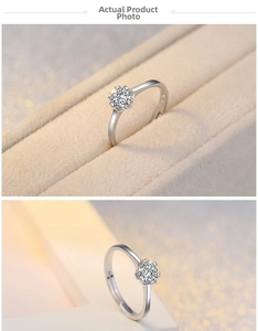 Detail of six-prong petal set zircon ring on a beige velvet jewelry gift box
