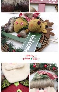 Close-up of a rustic Christmas wreath featuring reindeer, Santa dolls and a wooden Welcome sign