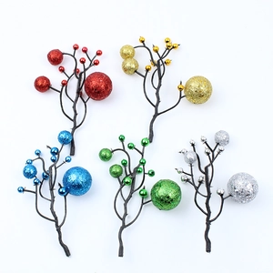 Detail of Christmas glitter berry branches in red, gold, blue, silver and green colors
