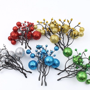 Macro shot of glittery Christmas berry stems in red, gold, silver, blue and green colors