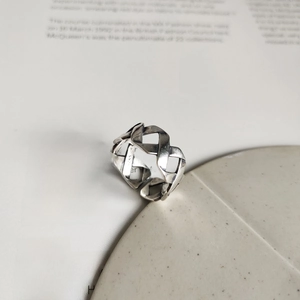 Macro detail of S925 sterling silver cross ring with vintage oxidized finish and hallmark