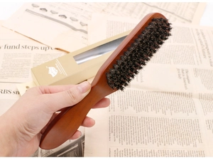 Detail of wooden beard brush with natural bristles in a vintage gift box set