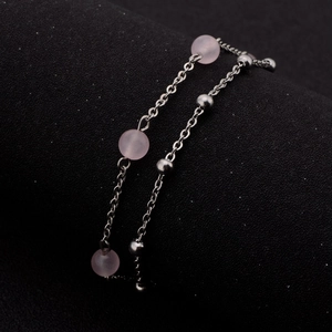 Close-up of double-layer stainless steel bracelet with pink quartz beads and silver spheres