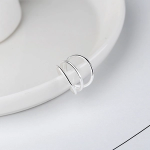 Chic S925 sterling silver three-layer ear cuff earring on white ceramic display