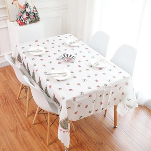 Christmas table runner with tree and wreath patterns on white fabric for holiday decor