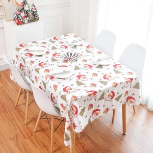 Christmas tablecloth with Santa Claus and tree prints on a festive dining table