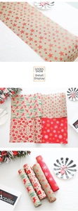 Detail of linen Christmas table runners featuring deer, stars, and snowflake prints