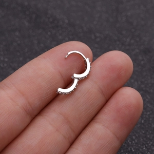 Minimalist silver zirconia hoop earrings for cartilage piercing worn on ear