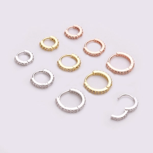 Mini zircon hoop earrings in silver gold and rose gold set on a pink background
