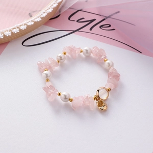 Pink irregular gemstone beaded bracelet with white pearls and small gold shoe charm
