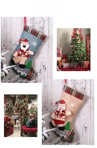 Detail of Christmas plaid burlap stockings with 3D snowman and bear dancing figurines