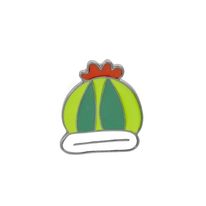 Close-up of a green enamel cactus pin with a red floral top and white planter base