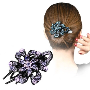 Detail of floral rhinestone hair clip with purple crystals and hollow petal design