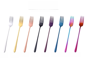 Macro view showing eight colorful stainless steel long handle forks with polished finish